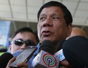 Presidential candidate Rodrigo Duterte talks to the media before boarding his flight for his hometown of Davao city in southern Philippines Friday, Feb. 12, 2016 at suburban Pasay city south of Manila, Philippines. Duterte, currently the mayor of Davao city and known for his tough stance in fighting against crime and drug trafficking,  cut short his campaign sortie in the north Tuesday and was admitted to a hospital in Manila for medical treatment.(AP Photo/Bullit Marquez)