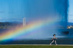 A walker passes a rainbow in the Captain Cook Jet on Thursday afternoon.