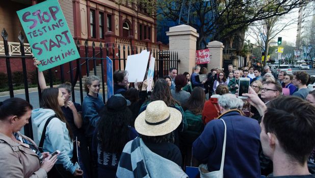 Students and parents protest outside at NSW Parliament.