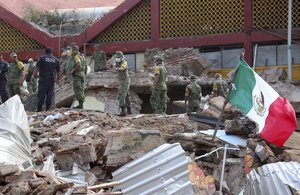 Soldiers remove debris from a partly collapsed municipal building felled by a massive earthquake in Juchitan, Oaxaca state, Mexico