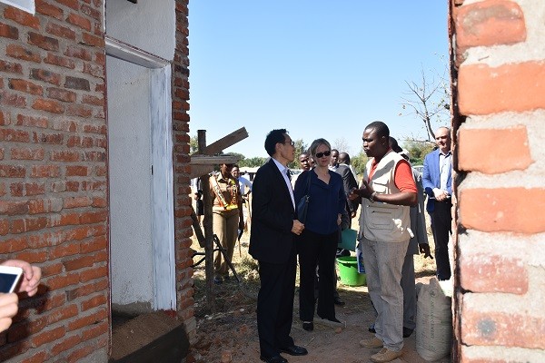 His Excellency Shi Ting Wang, Ambassador of China to Malawi, and Ms. Mia Seppo, the United Nations Resident Coordinator being briefed on the progress of the evacuation center