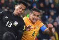 Tim Cahill and Thailand's Pansa Hemviboon go head to head for the ball.