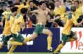 Glory boys: John Aloisi charges down the sideline after his famous penalty against Uruguay at ANZ Stadium in 2005.