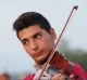 Syrian Rami Basisah plays for his fellow refugees at the Greece-Macedonia border in 2015.