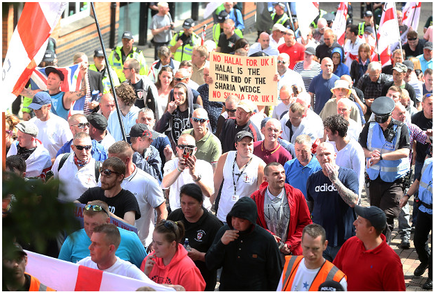 EDL marching in Nottingham featuring Ian kellett *Sunglasses and Union Jack scarf), Craig Burridge (white vest, cap, lanyard), Jack Stevens (black coat, hood up) and Daniel Hall (red shirt, black cap) 