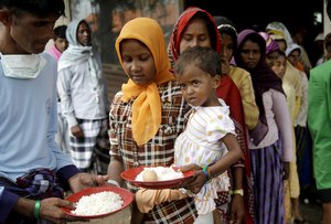 Ethnic Rohingya women queue up for food at a temporary shelter in Bayeun, Aceh province, Indonesia, Saturday, May 23, 2015.