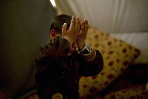 In this Friday, April 14, 2017 photo, Akram Rasho Khalaf, 10, pauses as he talks about being captured and trained by Islamic State militants, at Khabarto Camp for internally displaced people in Dahuk, Iraq. (AP Photo/Maya Alleruzzo)