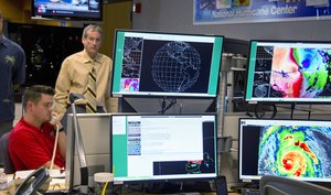 Hurricane Specialist Robbie Berg, left, and Ed Rappaport, right, the acting director of the National Hurricane Center, participate in a coordinating conference call for a Hurricane Irma forecast package Saturday, Sept. 9, 2017, at the hurricane center in Miami.