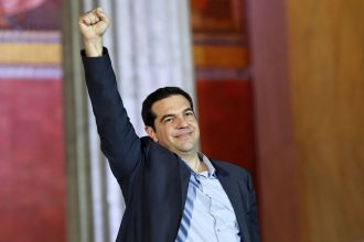 The head of radical leftist Syriza party Alexis Tsipras raises his fist to supporters after winning the elections in Athens January 25, 2015. Greek leftist leader Tsipras hailed the projected victory of his anti-austerity Syriza party in Sunday's snap election as a defeat for austerity and the EU/IMF bailout programme keeping the country afloat. REUTERS/Giorgos Moutafis (GREECE - Tags: POLITICS ELECTIONS BUSINESS TPX IMAGES OF THE DAY)