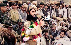 Nek Mohammed in front of a microphone during the signing of the peace accord on April 24, 2004. 