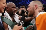 Floyd Mayweather Jr, left, speaks with Conor McGregor after winning the super welterweight boxing match 
 on Saturday.