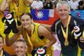 The Emerging Opals celebrate their gold medal win at the World University Games. Coach Chris Lucas is second from right.