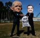 Protestors wearing suits resembling Prime Minister Malcolm Turnbull and Adani chief Gautam Adani take part in a protest ...