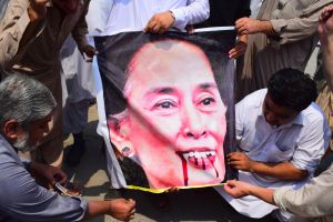 Pakistani protesters burn a caricature of Aung San Suu Kyi in a protest against ongoing violence against the Rohingya ...