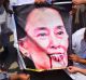 Pakistani protesters burn a caricature of Aung San Suu Kyi in a protest against ongoing violence against the Rohingya ...