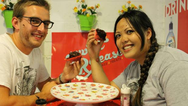 050215 News photo: Journey of Hope founder Alfie Butler shows Sweet Release bakery director Kristine Bartley how to ...