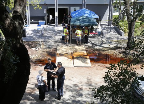 Police officers talk to an employee at the Rehabilitation Center at Hollywood Hills in Hollywood, Fla., Wednesday, Sept. 13, 2017.