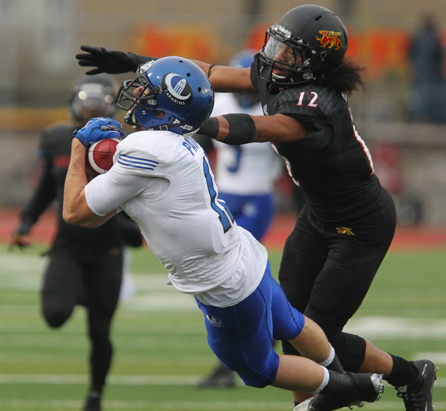 Montreal Carabines' Guillaume Paquet makes a catch as defended by Guelph Gryphons' Royce Metchie during the first half of CIS Mitchell Bowl football championship game in Guelph, Ont., on Saturday, November 21, 2015. THE CANADIAN PRESS/Dave Chidley