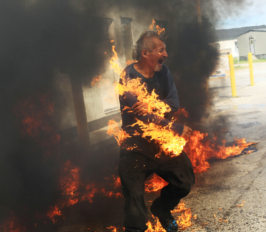 Pierre George, the brother of killed protester Dudley George, is engulfed in flames after attempting to pour gasoline on a fire during a protest against a community march intended to "walk home" to the gates of the former Camp Ipperwash on Sunday, Sept. 20, 2015, in London, Ontario. The land is being returned to the Kettle and Stony Point First Nation after being expropriated by the Federal government during the Second World War. THE CANADIAN PRESS/Dave Chidley