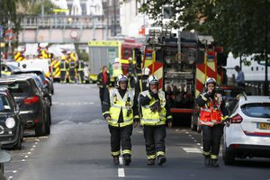 Fire brigade officers walk within a cordon near where an incident happened, that police say they are investigating as a terrorist attack, at Parsons Green subway station in London, Friday, Sept. 15, 2017