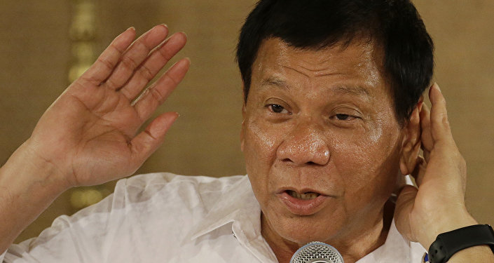 Philippine President Rodrigo Duterte gestures as he answers questions from reporters during a press conference