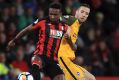 AFC Bournemouth's Jermain Defoe, left, and Brighton & Hove Albion's Shane Duffy vie for the ball.