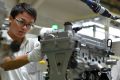 A worker assembles an engine at the General Motors plant in Wuhan, central China.
