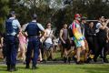 A heavy police presence greets revellers at the Defcon.1 dance festival.