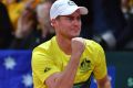 Australian team captain Lleyton Hewitt celebrates John Millman winning the first set against David Goffin.