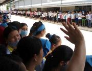 Various striking workers gather around a central courtyard.