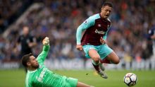 West Bromwich Albion goalkeeper Ben Foster, left, slides in on West Ham United's Javier Hernandez during the English ...