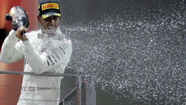 Lewis Hamilton celebrates on the podium.