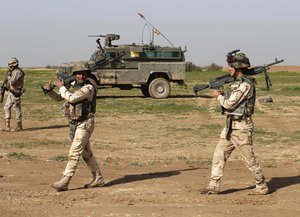 FILE - In this Sunday, Jan. 24, 2016 file photo, Armed forces use live ammunition in training exercises at Basmaya base, 40 kilometers southeast of Baghdad, Iraq. U.S. and Iraqi officials cast Ramadi as proof that coalition training efforts have paid off and the Iraqi military has improved since its catastrophic collapse in the summer of 2014.