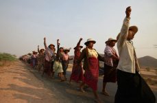 Villagers protest against a copper mine project during a visit by Myanmar pro-democracy leader Aung San Suu Kyi in Sarlingyi township