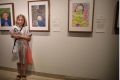 Poppy Barnes next to her winning work at the Young Archie art contest.