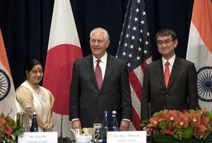 U.S. Secretary of State Rex Tillerson, center, stands with Indian External Affairs Minister Sushma Swaraj, left, and Japanese Foreign Minister Taro Kono, at the Palace Hotel during a meeting in New York, Monday, Sept. 18, 2017.