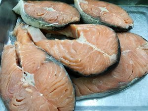 Fresh cut salmon slices placed on an aluminum pan. Taken on April 2017.