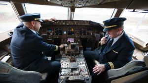 United Airlines Captain Tommy Holloman, left, and Captain Chuck Stewart, in the cockpit of an United Airlines Boeing 777 ...