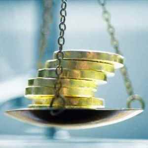 Gold Coins Being Weighed on Scale