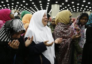 Muslim women pray before Muhammad Ali's Jenazah, a traditional Islamic Muslim service, in Freedom Hall, Thursday, June 9, 2016, in Louisville, Ky.