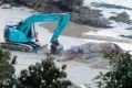 The dead whale being buried on Nobbys Beach, Port Macquarie. 