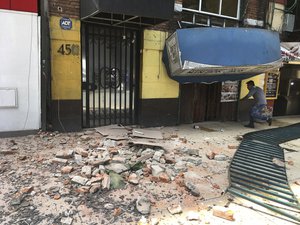 A man enters to a damage building damaged  after a earthquake in Mexico City, Tuesday, Jan. 19, 2017.