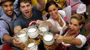 Young people celebrate the opening of the 184th Oktoberfest beer festival in Munich, Germany, Saturday, Sept. 16, 2017. ...