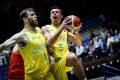 Australia's Jason Cadee attempts a layup as he runs into teammate Nick Kay. 