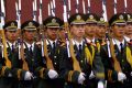 Chinese soldiers with fixed bayonets attend the flag-raising ritual at dawn in Tiananmen Square.