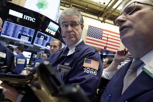 Trader Daniel Krieger, center, works on the floor of the New York Stock Exchange - Solid Chinese manufacturing data helped shore up global stock markets