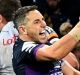 Just reward: Billy Slater celebrates after taking the game beyond Brisbane's reach.