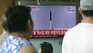 People watch a TV news program showing a file image of a missile being test-launched by North Korea, at Seoul Railway Station in Seoul, South Korea, Tuesday, July 4, 2017.