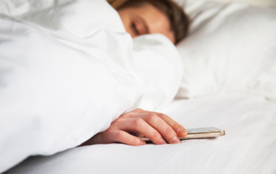 woman sleeping in bed being woken by mobile phone; Shutterstock ID 549027304; PO: purchase_order4; Job: job1; Client: client2; Other: other3