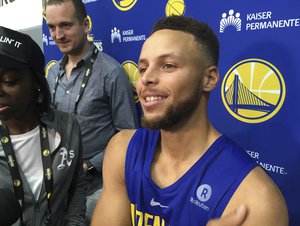 Golden State Warriors Stephen Curry takes questions from the media after NBA basketball practice in Oakland, Calif., Saturday, Sept. 23, 2017. President Donald Trump doubled down on denouncing protests by NFL players and rescinded NBA star Stephen Curry's White House invitation on Saturday.